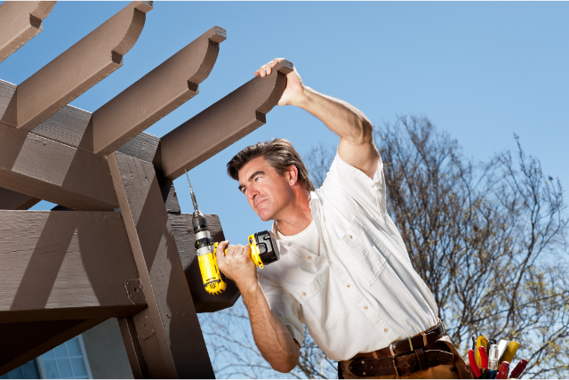 Handyman Working On Pergola